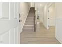 Light and airy entryway featuring wood floors and staircase at 89 Jumper St, Wendell, NC 27591