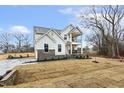 Attractive two-story home showcases white siding, stone accents, and a welcoming covered balcony at 89 Jumper St, Wendell, NC 27591
