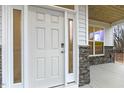 Close-up of a white front door with sidelights and stone trim at 89 Jumper St, Wendell, NC 27591