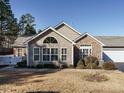 Ranch home with stone accents, sunroom, and fenced backyard at 992 Blue Bird Ln, Wake Forest, NC 27587