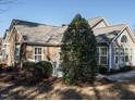 Side view of the house showcasing a sunroom and landscaping at 992 Blue Bird Ln, Wake Forest, NC 27587