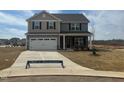 Beautiful new home with stone accents, gray siding, and two-car garage in a Gathering-friendly neighborhood at 107 Wilderness Ct, Mebane, NC 27302