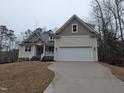 Charming home with a two-car garage, manicured lawn, and inviting curb appeal in a serene setting at 143 Oswego Dr, Louisburg, NC 27549