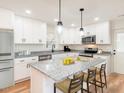 Modern kitchen featuring stainless steel appliances and a large island at 436 Southern High School Rd, Graham, NC 27253