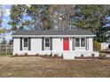 Charming single story home with red door and landscaped lawn at 124 W College St, Oxford, NC 27565