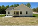 Exterior view showcasing the back of this beautiful single-Gathering home, with a covered patio at 19 Covey Rise Way, Lillington, NC 27546
