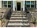 Exterior front entrance with stone steps and black door at 19 Covey Rise Way, Lillington, NC 27546
