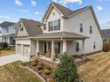 Beautiful home with a welcoming front porch, swing and well-manicured landscaping, complementing its classic exterior at 316 Spruce Pine Trl, Knightdale, NC 27545