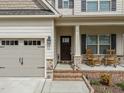 Charming home with a welcoming front porch, featuring rocking chairs and a well-manicured yard at 316 Spruce Pine Trl, Knightdale, NC 27545