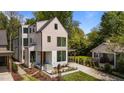 Modern two-story home with a white and tan exterior, large windows, and minimalist front yard landscaping at 339 1/2 Mulberry St, Raleigh, NC 27604