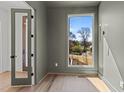 Bright room with hardwood flooring, a neutral wall color, and a view of mature trees at 339 1/2 Mulberry St, Raleigh, NC 27604