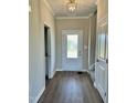 Inviting entryway with hardwood floors, white trim, and a front door with decorative frosted glass at 40 Misty Mountain, Spring Hope, NC 27882