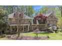 A well-maintained brick home with dormer windows and a covered front porch at 5317 Burning Oak Ct, Raleigh, NC 27606