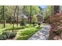 Traditional brick home with beautiful mature trees and a long driveway at 5317 Burning Oak Ct, Raleigh, NC 27606
