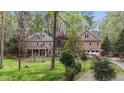 Charming brick home with a manicured lawn, mature trees, and attached two-car garage at 5317 Burning Oak Ct, Raleigh, NC 27606