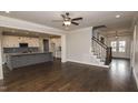 Spacious living room with hardwood floors, fireplace and kitchen view at 6737 Dwight Rowlad Rd, Willow Springs, NC 27592