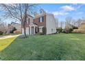 Two-story house with partial brick and siding, and a grassy yard at 900 Blue Thorn Drive Dr, Apex, NC 27539