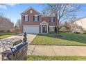 Two-story brick home with a large front yard and mailbox at 900 Blue Thorn Drive Dr, Apex, NC 27539