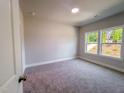 Cozy bedroom with plush carpeting, large windows, and neutral paint at 207 Pond View Ct # 3, Fuquay Varina, NC 27526