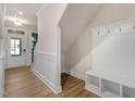 Entryway with drop zone, bench, coat hooks, wood-look flooring, and door to outside at 207 Pond View Ct # 3, Fuquay Varina, NC 27526