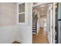 View of an entryway with hardwood floors, and an interior view of the staircase at 207 Pond View Ct # 3, Fuquay Varina, NC 27526