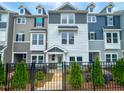 Charming townhouse with a well-manicured lawn and black metal fence at 207 Pond View Ct # 3, Fuquay Varina, NC 27526