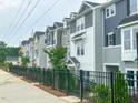 A row of townhouses with different colors and black fences at 207 Pond View Ct # 3, Fuquay Varina, NC 27526