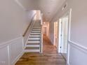 Bright hallway featuring stairs, neutral walls, and wood-look flooring at 207 Pond View Ct # 3, Fuquay Varina, NC 27526