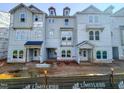 New construction townhomes with modern design elements and covered entryway at 209 Pond View Ct # 4, Fuquay Varina, NC 27526