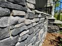 Close-up of a stone wall, highlighting the texture and craftsmanship at 262 Grand Griffon Way, Lillington, NC 27546