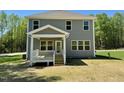 Rear view of house showing siding, windows, and a small porch at 45 Covey Rise Way, Lillington, NC 27546