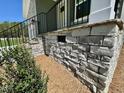 Stone wall outside, landscaping includes shrubs and ground cover at 45 Covey Rise Way, Lillington, NC 27546