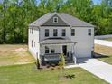 Charming two-story home boasts a well-maintained lawn and inviting front porch at 63 Whimbrel Ct, Lillington, NC 27546