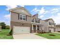 Exterior of a two-story home featuring a brick and siding exterior with a two-car garage at 107 Ethel Ln, Angier, NC 27501