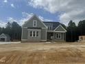 New construction two-story home featuring neutral siding and brickwork with a detached garage at 136 Bar Code Ct, Wendell, NC 27591