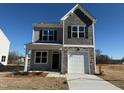 Charming two-story home with a stone-accented garage and covered front porch at 346 Tormore, Homesite 125, Sanford, NC 27330