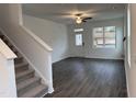 Bright, open-concept living area with wood floors, staircase, and natural light at 346 Tormore, Homesite 125, Sanford, NC 27330