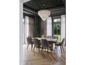 Elegant dining room featuring a modern chandelier, neutral color palette, and views of the outdoor greenery at 5001 Rampart St, Raleigh, NC 27609