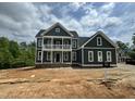 New construction home with a two-story facade, showcasing balcony, landscaping, and modern design at 71 Slocum Dr, Wendell, NC 27591