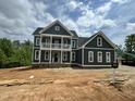 Exterior of a new construction home featuring a balcony, landscaping possibilities, and modern design elements at 71 Slocum Dr, Wendell, NC 27591