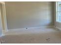 Bright living room with neutral paint, white trim, and large window, offering a blank canvas for personalization at 71 Slocum Dr, Wendell, NC 27591