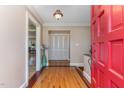Bright entryway with hardwood floors, red door, and view to living room at 129 Jeffress Dr, Louisburg, NC 27549