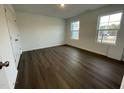 Bright bedroom with hardwood floors and two large windows at 1309 Hazelnut Ridge Ln, Knightdale, NC 27545