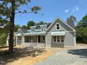 Inviting exterior with stone accents, stylish windows, and a welcoming entrance at 172 Quail Pt, Pittsboro, NC 27312