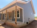 Gray two-story home with covered porch, brick foundation, and gray siding at 2850 Sheep Pasture Rd, Spring Hope, NC 27882