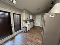 Kitchen with white cabinets and wood-look floors at 3508 Guess Rd, Durham, NC 27705