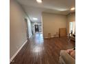 Living room with wood-look floors and view to dining area at 3508 Guess Rd, Durham, NC 27705