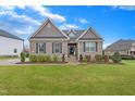 Inviting brick home featuring a lush green lawn, well-maintained shrubbery, and classic curb appeal at 4236 Aviemore, Burlington, NC 27215