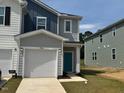Charming two-story home featuring a one car garage and beautifully landscaped front yard at 10548 Brookside Reserve Rd, Raleigh, NC 27614