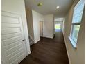 Inviting home entryway featuring dark wood flooring and a staircase leading to the upper level at 10548 Brookside Reserve Rd, Raleigh, NC 27614